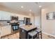 Well-lit kitchen featuring white cabinets, granite countertops, and stainless steel appliances at 9853 Bangalore Ct, Las Vegas, NV 89148