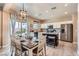 Modern kitchen with an island, stainless steel appliances, and an adjacent dining area at 9853 Bangalore Ct, Las Vegas, NV 89148