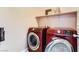 Modern laundry room featuring front-load Samsung washer and dryer set, with storage shelf above at 9853 Bangalore Ct, Las Vegas, NV 89148