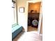 Laundry room with window, front loading washer and dryer, and bench seating at 9853 Bangalore Ct, Las Vegas, NV 89148