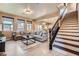 Comfortable living room with a staircase and an open view to the kitchen at 9853 Bangalore Ct, Las Vegas, NV 89148