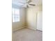 Bedroom featuring neutral carpet, window with blinds, and ceiling fan at 10190 Deerfield Beach Ave # 202, Las Vegas, NV 89129