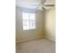 Cozy bedroom with neutral carpet, window, and ceiling fan at 10190 Deerfield Beach Ave # 202, Las Vegas, NV 89129