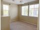 Comfortable bedroom with large windows and neutral carpeting at 10190 Deerfield Beach Ave # 202, Las Vegas, NV 89129