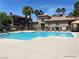 A pristine pool area surrounded by palm trees and lounge chairs offers a relaxing outdoor space at 10190 Deerfield Beach Ave # 202, Las Vegas, NV 89129
