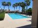 A stunning pool is surrounded by palm trees, lounge chairs, and lush landscaping for residents at 10190 Deerfield Beach Ave # 202, Las Vegas, NV 89129