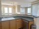 Well-lit kitchen with a breakfast bar, stainless steel dishwasher, and double sink at 10190 Deerfield Beach Ave # 202, Las Vegas, NV 89129