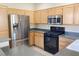 Kitchen with stainless steel refrigerator and black gas range at 10190 Deerfield Beach Ave # 202, Las Vegas, NV 89129