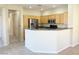 Well-lit kitchen offering stainless steel appliances and breakfast bar seating at 10190 Deerfield Beach Ave # 202, Las Vegas, NV 89129
