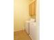 Bright laundry room with washer, dryer, and storage cabinet at 10190 Deerfield Beach Ave # 202, Las Vegas, NV 89129