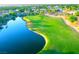 Aerial of green golf course with a lake, showcasing community's outdoor amenities and scenic beauty at 10248 Maggira Pl, Las Vegas, NV 89135