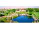 Lush landscaping with a lake and golf course views, offering serene outdoor beauty and recreational amenities at 10248 Maggira Pl, Las Vegas, NV 89135