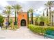 Elegant arched entrance to a building with manicured landscaping and inviting pathway at 10248 Maggira Pl, Las Vegas, NV 89135