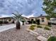 Charming single-story home with desert landscaping, palm trees, and a paved driveway at 10248 Maggira Pl, Las Vegas, NV 89135