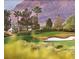 Picturesque golf course landscape with sand traps, palm trees, and a backdrop of mountains at 10248 Maggira Pl, Las Vegas, NV 89135