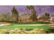 Scenic view of a lush golf course with well-manicured greens and distant mountain backdrop at 10248 Maggira Pl, Las Vegas, NV 89135