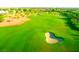 Expansive green golf course view featuring manicured lawns, bunkers, and lush surroundings for an exceptional recreational experience at 10248 Maggira Pl, Las Vegas, NV 89135