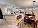 Spacious kitchen and breakfast nook featuring tile flooring, granite countertops, and stainless steel appliances at 10248 Maggira Pl, Las Vegas, NV 89135