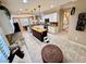 Bright kitchen featuring granite countertops, a center island, and modern appliances at 10248 Maggira Pl, Las Vegas, NV 89135