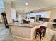 Open kitchen with a breakfast bar, a central island, and pendant lighting at 10248 Maggira Pl, Las Vegas, NV 89135