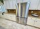 Modern kitchen with stainless steel refrigerator and white cabinetry offering ample storage at 10248 Maggira Pl, Las Vegas, NV 89135