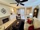 Inviting living room with a fireplace, tile flooring, and comfortable seating, perfect for relaxation at 10248 Maggira Pl, Las Vegas, NV 89135