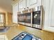 Modern microwave with stainless steel finish above the stove with white cabinets and granite countertops at 10248 Maggira Pl, Las Vegas, NV 89135