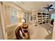 Comfortable home office featuring built-in shelving, shutters and a ceiling fan at 10248 Maggira Pl, Las Vegas, NV 89135
