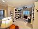 Bright home office featuring custom built-in shelving, shutters, and neutral carpeting at 10248 Maggira Pl, Las Vegas, NV 89135