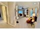 Spacious home office with custom built-in shelving, shutters and a ceiling fan at 10248 Maggira Pl, Las Vegas, NV 89135