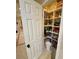Well-organized walk-in pantry with tiled floor and shelves stocked with food items at 10248 Maggira Pl, Las Vegas, NV 89135