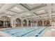 Stunning indoor pool with skylights and ornate architectural details, offering a luxurious experience at 10248 Maggira Pl, Las Vegas, NV 89135