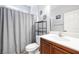 Functional bathroom featuring a single sink vanity, toilet, and a shower/tub combination with a gray curtain at 1141 Brent Park Ct, Henderson, NV 89002