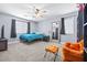 Comfortable bedroom with neutral tones, carpet, and a cozy orange chair provides a relaxing retreat at 1141 Brent Park Ct, Henderson, NV 89002