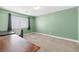 Spacious bedroom with green walls and plush carpeting offering a cozy and inviting atmosphere at 1141 Brent Park Ct, Henderson, NV 89002