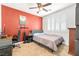 Comfortable bedroom with a modern bed, desk, ceiling fan, and natural light from shuttered windows at 1141 Brent Park Ct, Henderson, NV 89002