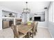 Elegant dining area with a wooden table set for eight, decorative lighting, and views into the living room at 1141 Brent Park Ct, Henderson, NV 89002