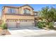 Charming two-story home with a three-car garage, desert landscaping, and a welcoming entrance at 1141 Brent Park Ct, Henderson, NV 89002