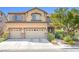 Two-story home features a three-car garage, well-maintained landscaping, and inviting curb appeal at 1141 Brent Park Ct, Henderson, NV 89002