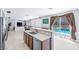Well-lit kitchen featuring a breakfast bar that opens onto a backyard with a pool, offering seamless indoor/outdoor living at 1141 Brent Park Ct, Henderson, NV 89002