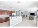 Bright, open kitchen with wood cabinets, stone countertops, stainless appliances, and an adjacent dining area at 1141 Brent Park Ct, Henderson, NV 89002