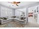 Spacious living area with a large sectional sofa, shuttered windows, and an open view into the dining area at 1141 Brent Park Ct, Henderson, NV 89002