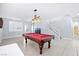 The living room features a pool table, tiled flooring, and access to the upstairs area at 1141 Brent Park Ct, Henderson, NV 89002