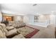 Bright upstairs living room area featuring plush sofas, a built-in bookcase, and a staircase with white railing at 1141 Brent Park Ct, Henderson, NV 89002