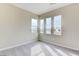 This bedroom has neutral carpet and paint, and three windows for ample natural light at 11840 Pelican Butte Ave, Las Vegas, NV 89138