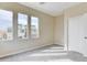 This bedroom has neutral carpet and paint, and three windows with neighborhood views at 11840 Pelican Butte Ave, Las Vegas, NV 89138