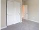 This bedroom features neutral carpet and walls, with closet that has sliding doors at 11840 Pelican Butte Ave, Las Vegas, NV 89138
