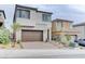 A modern two-story home with brick accents, a driveway, and a two-car garage at 11840 Pelican Butte Ave, Las Vegas, NV 89138