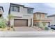 A modern two-story home with brick accents, a driveway, and a two-car garage at 11840 Pelican Butte Ave, Las Vegas, NV 89138