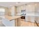 Kitchen with island and stainless steel appliances, with lots of light and neutral tones at 11840 Pelican Butte Ave, Las Vegas, NV 89138